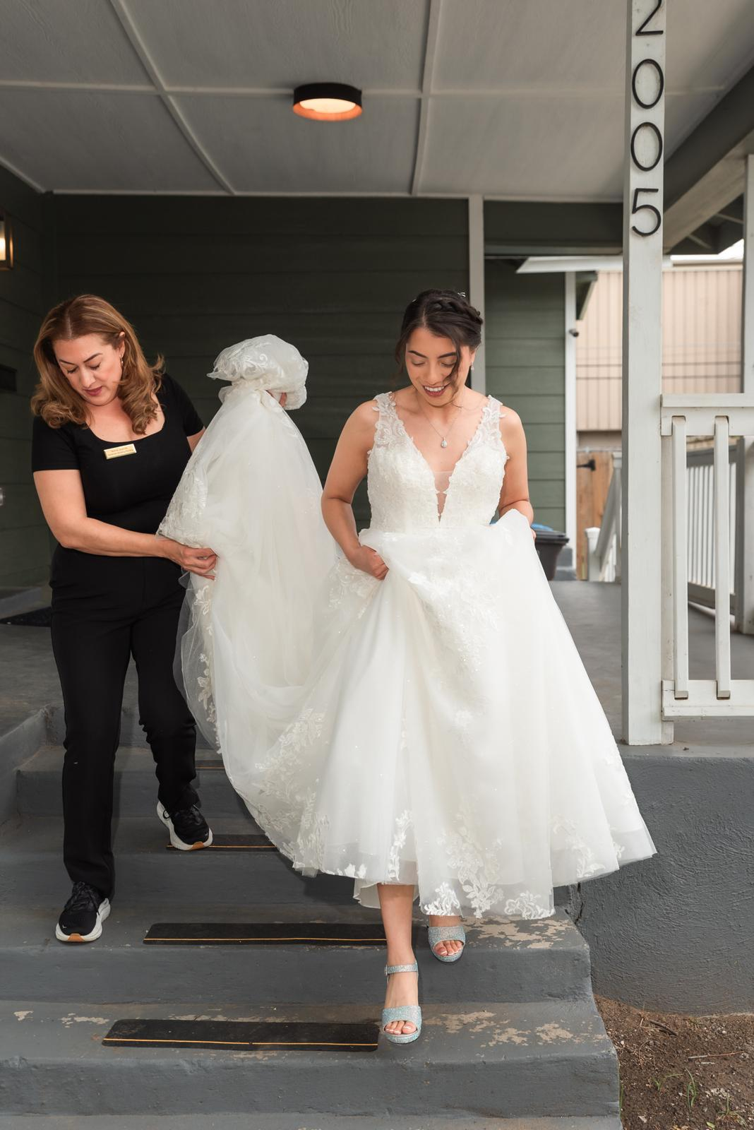 Planner assisting the bride with her gown before the ceremony